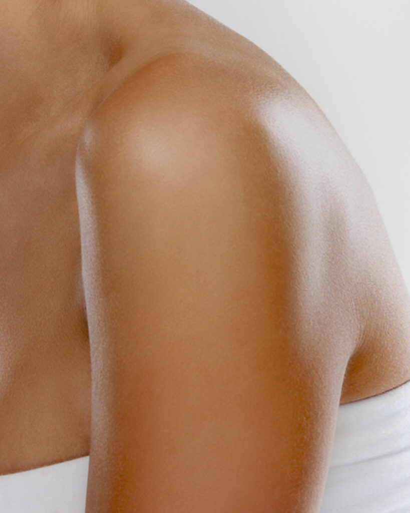 Woman's arm and shoulder with Luminous Dry Body Oil